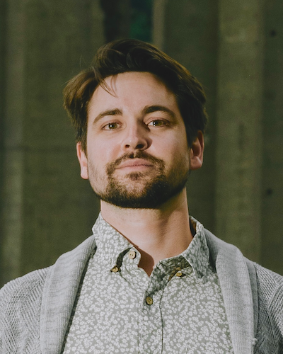 portrait photo of Tannor in a gray sweater